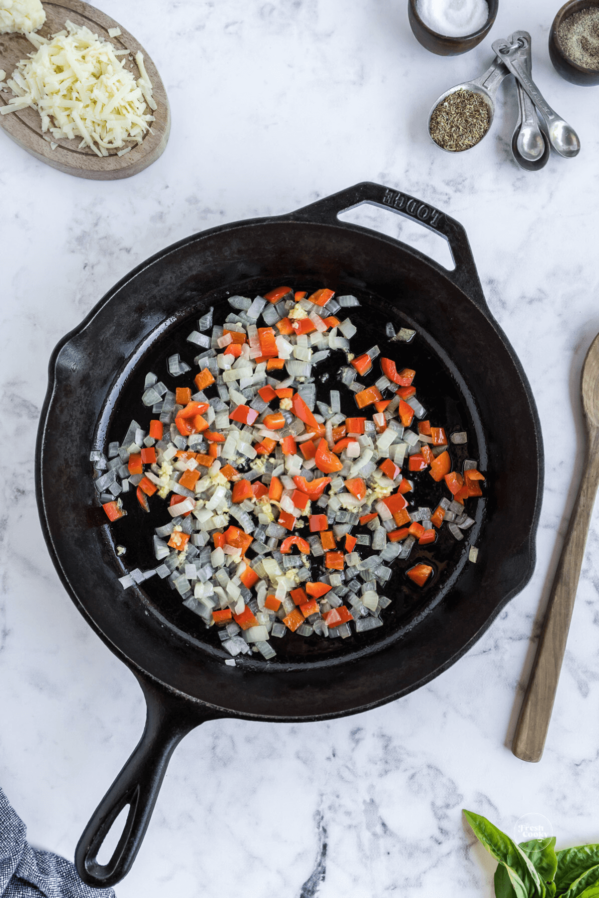 Sauteing peppers, onions and garlic in cast iron skillet.