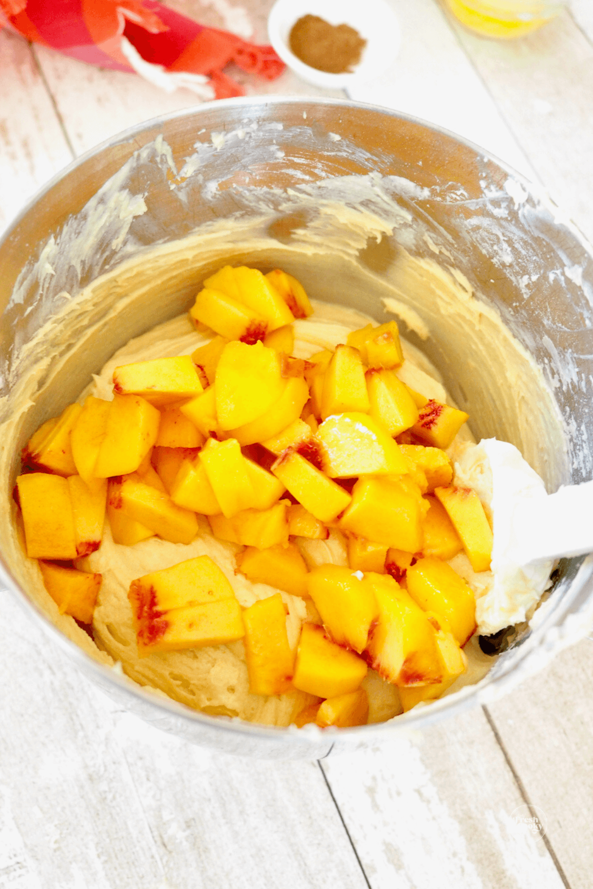 Folding peaches into cake batter. 