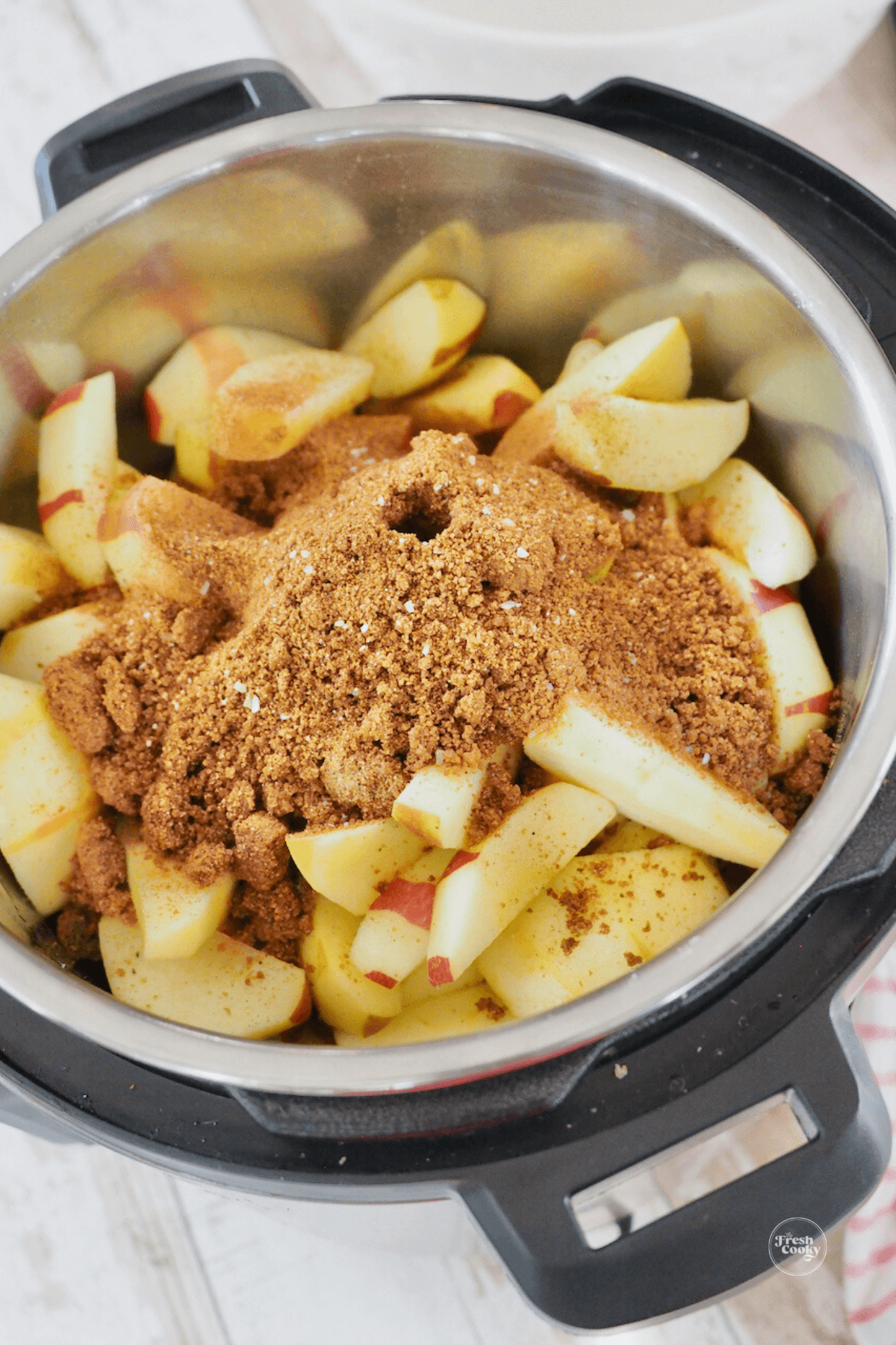 Brown sugar and spices on top of apples in instant pot. 