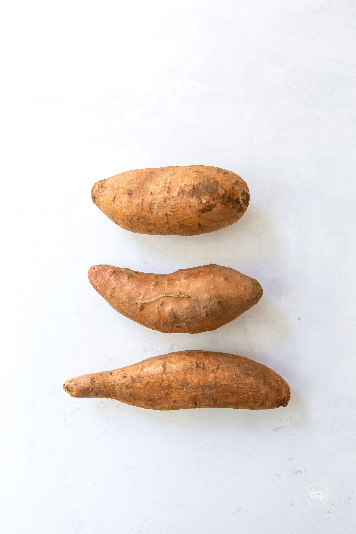 Three similar sized sweet potatoes. 