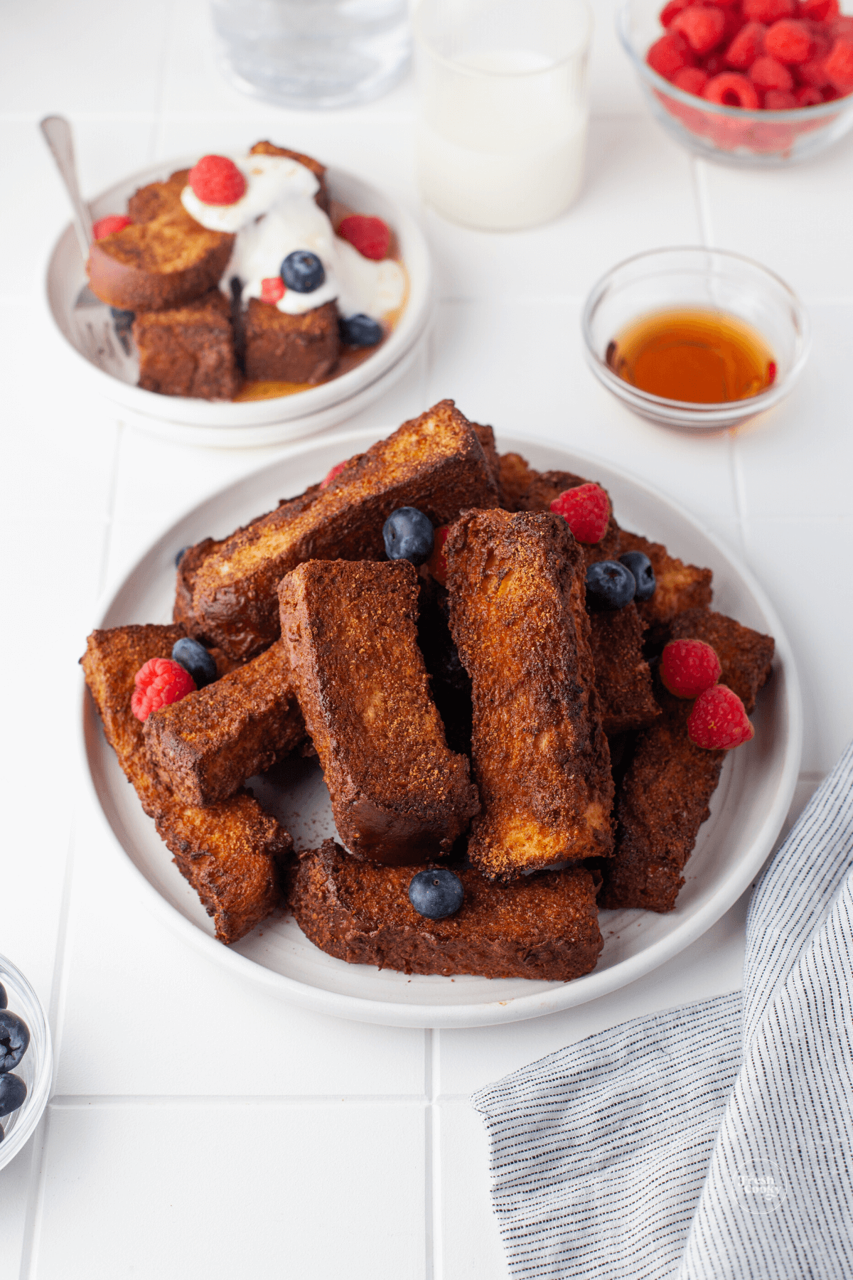 Air fried french toast sticks on plate.