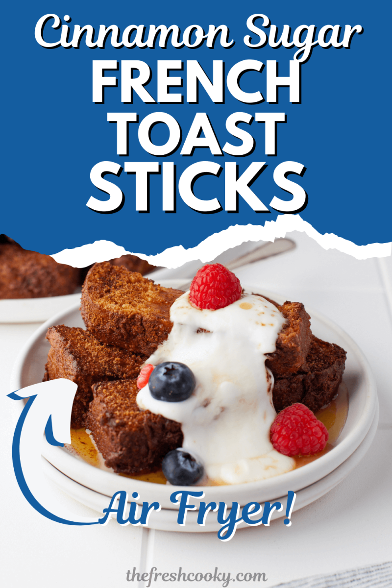 Plate of french toast sticks that were made in air fryer drizzled in cream and berries, for pinning.