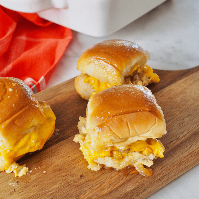 Easy Breakfast Egg Sandwiches three on a wooden board.