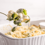 Broccoli au gratin with spoon serving.