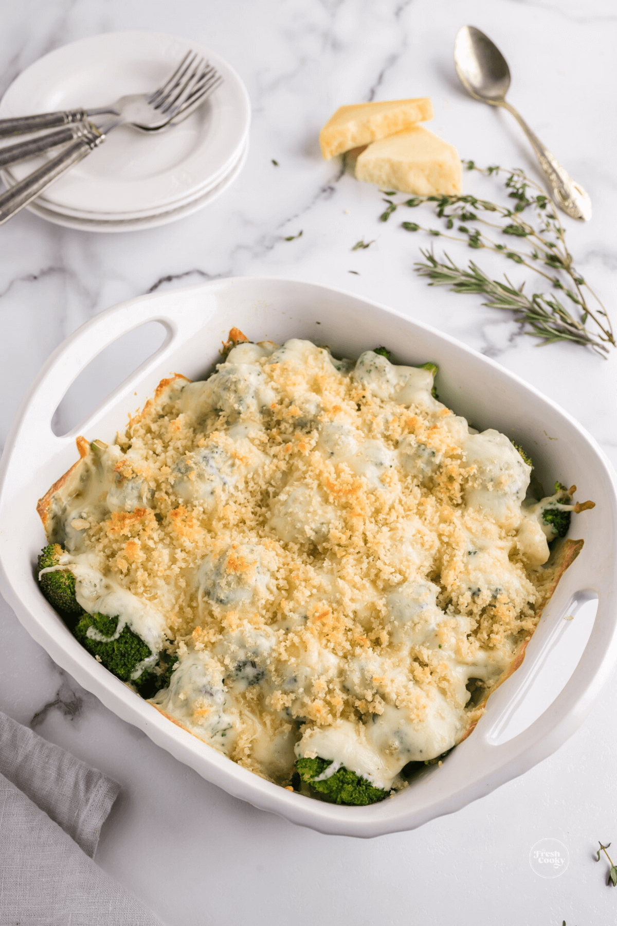 Baker filled with broccoli au gratin baked and on table.