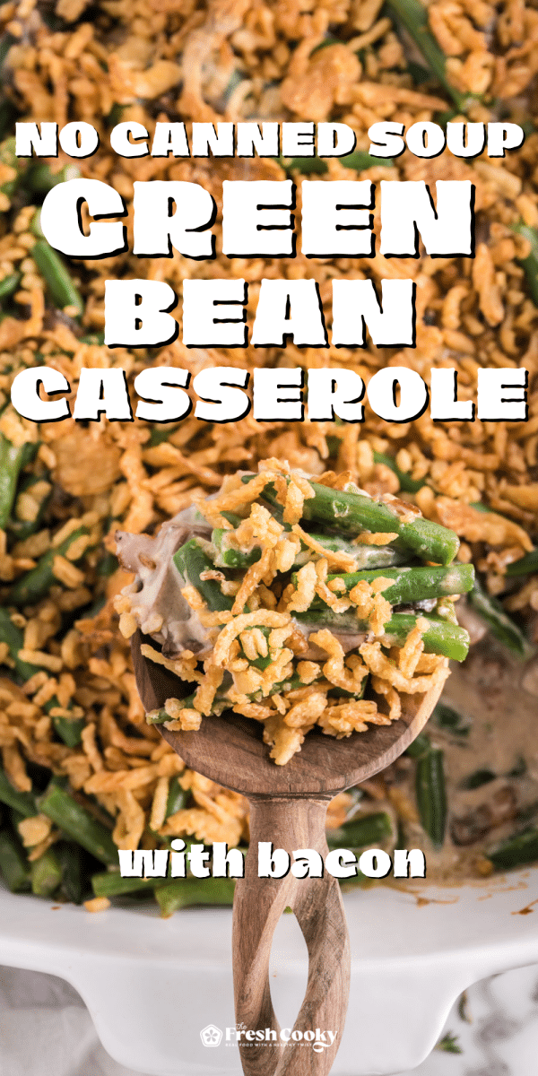 Green bean casserole with wooden spoon holding a serving, to pin.