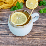Starbucks Copycat Medicine Ball tea in a pretty ceramic mug with a wheel of lemon.