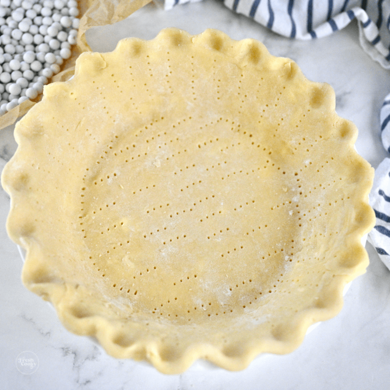 3 ingredient pie crust in plate, crimped and docked, ready for oven.