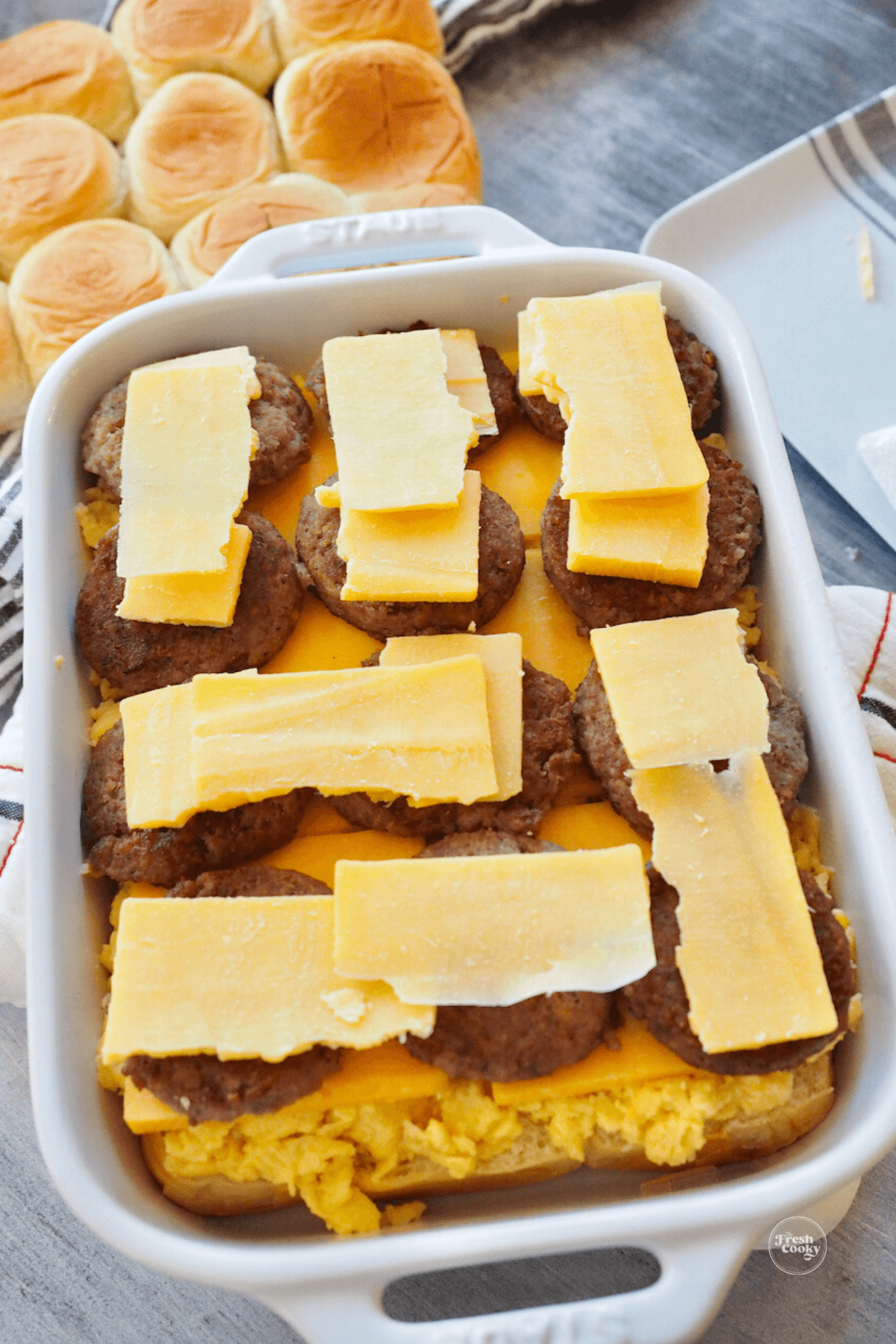 Sliced cheddar cheese on top of sausage patties. 