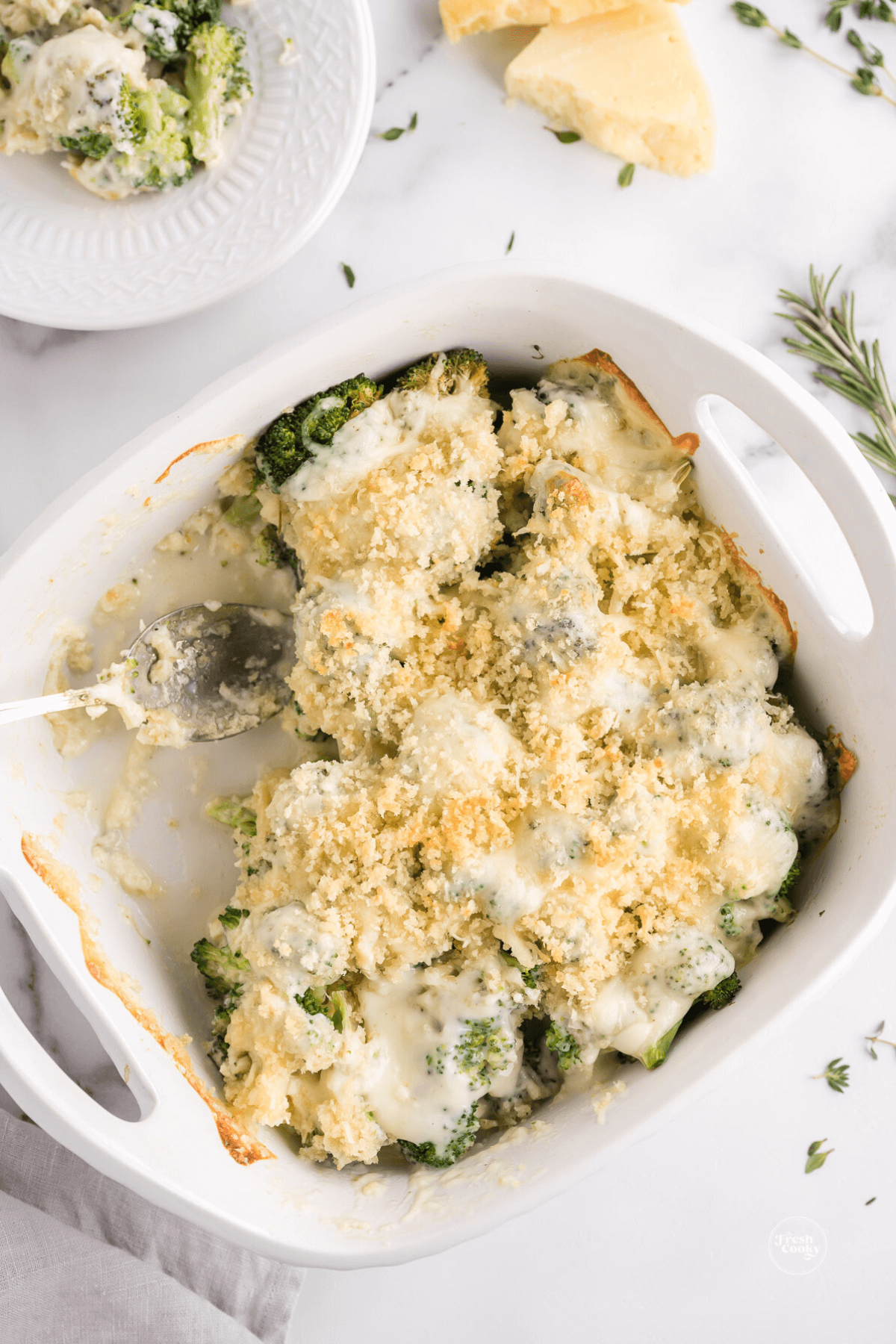 Broccoli au gratin in baker with serving removed.