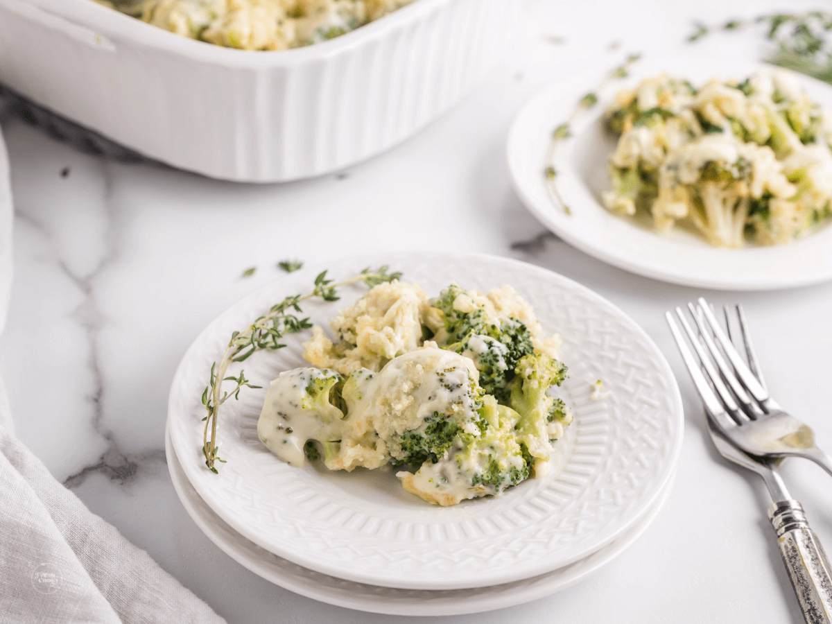 Servings of broccoli gratin on plates with forks.
