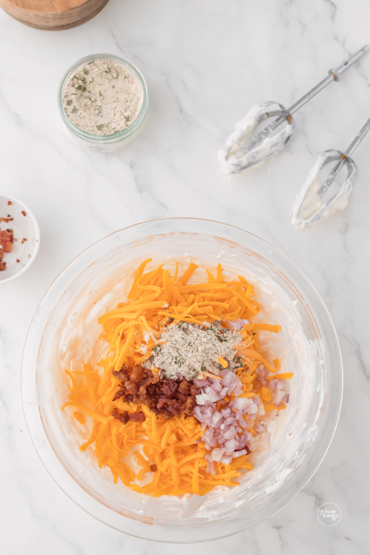 Add in bacon bits, shallots, cheese and ranch dressing to cream cheese dip. 