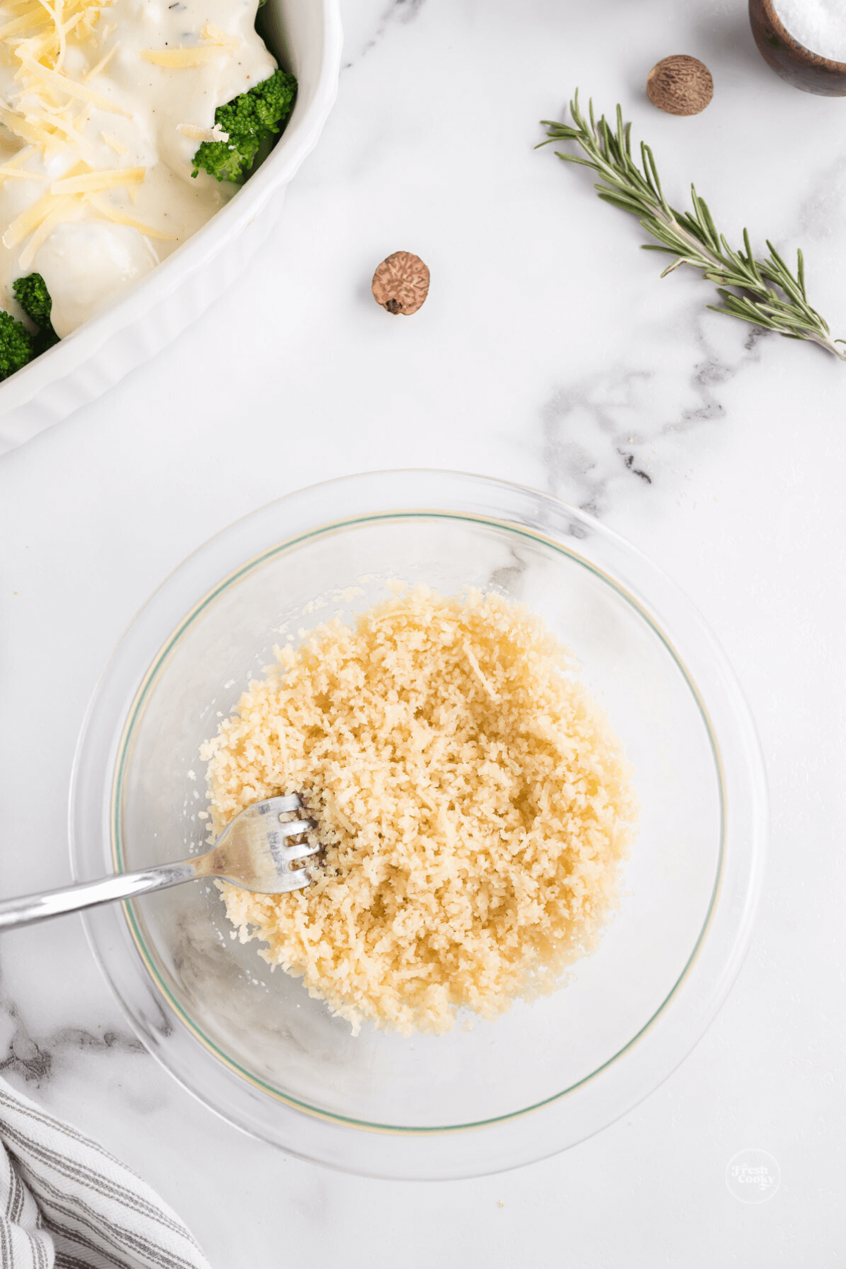Stirring together panko, butter and parmesan.