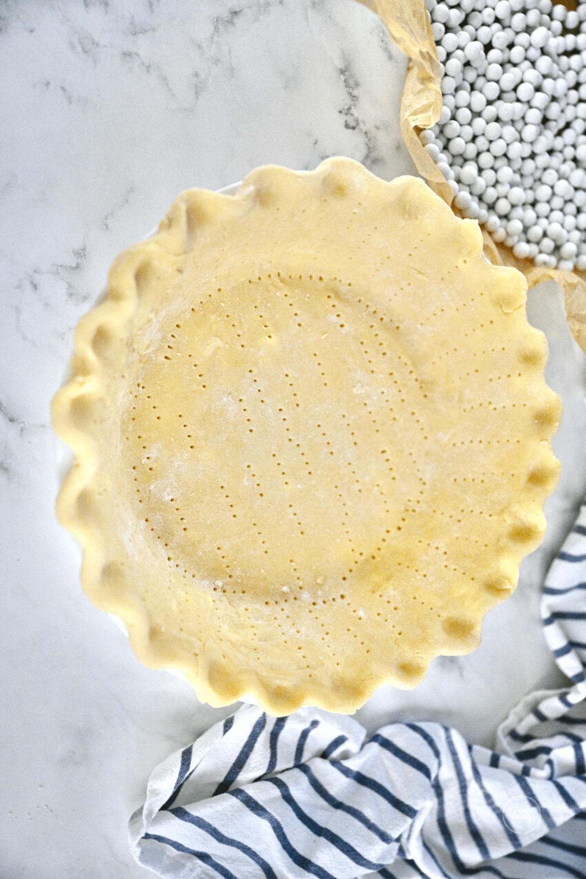 Crimped pie dough in pie plate.