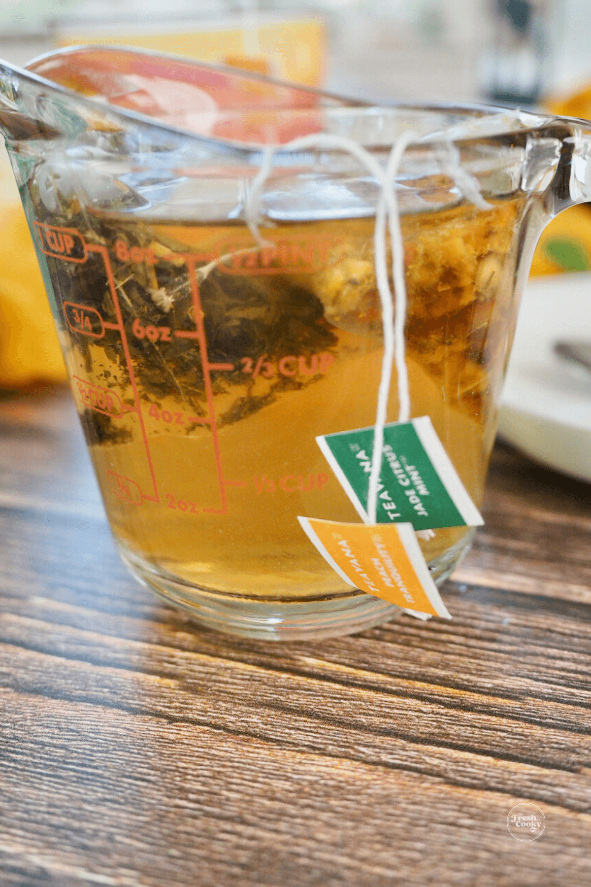 Both tea bags in a one cup measuring cup steeping.