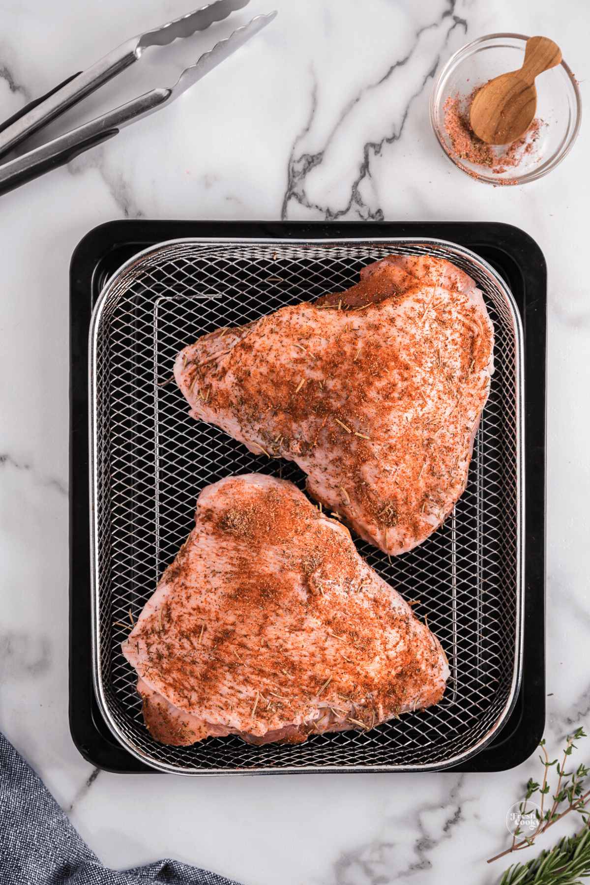 Place turkey thighs on air fryer rack. 