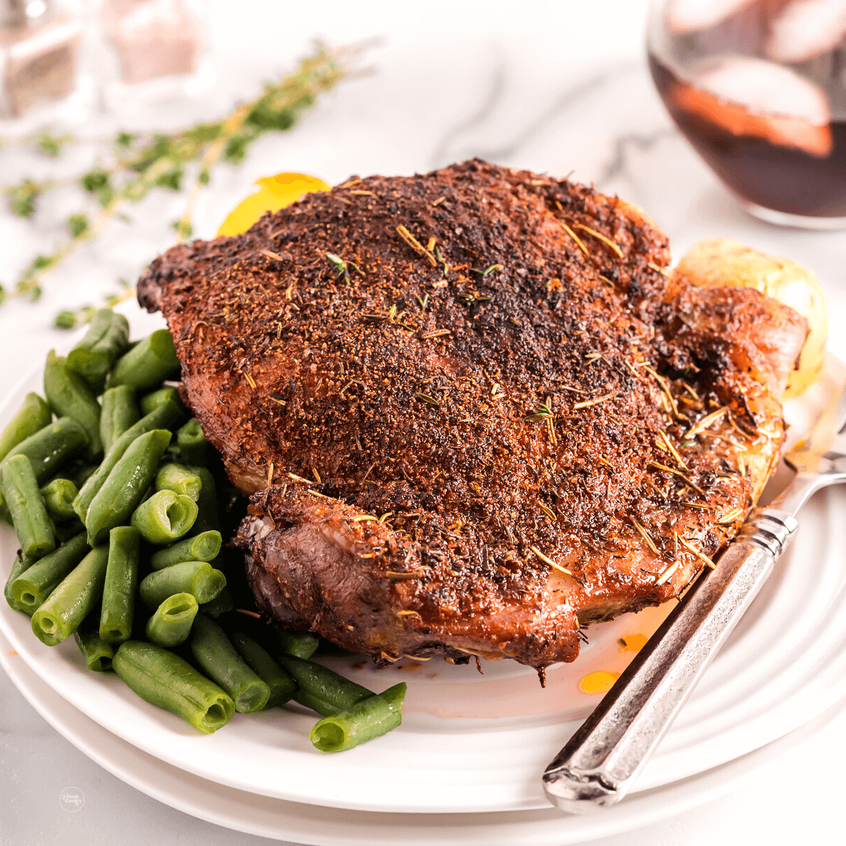 Air Fryer Turkey Thigh on plate with veggies.