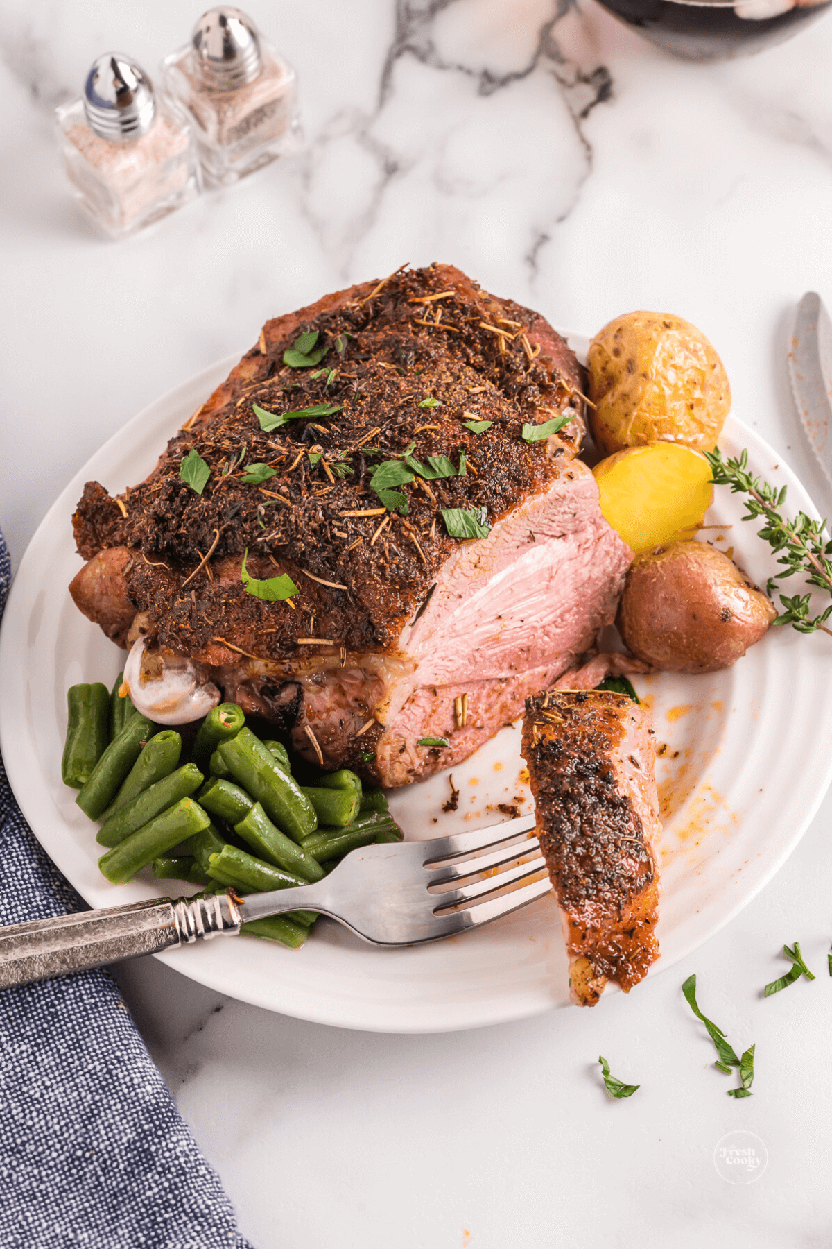 Air Fryer turkey thigh on plate sliced with fork.