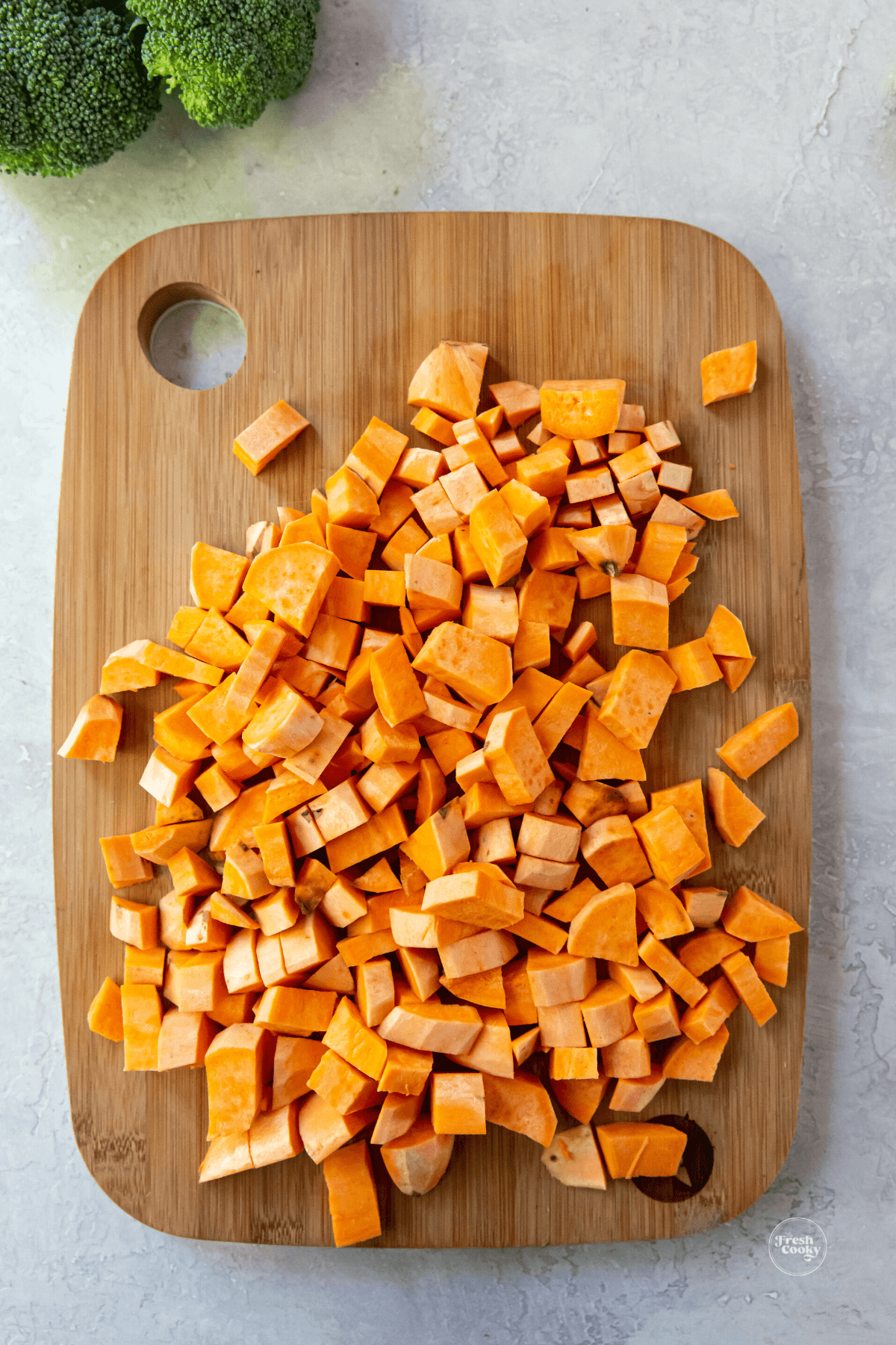 Cubed sweet potatoes on cutting board. 
