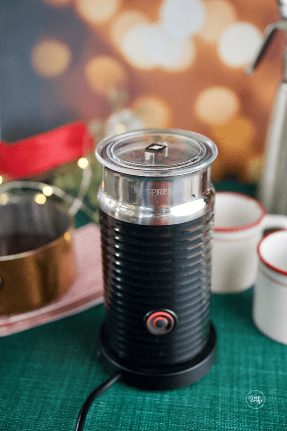 Nespresso frother making foamed half and half.