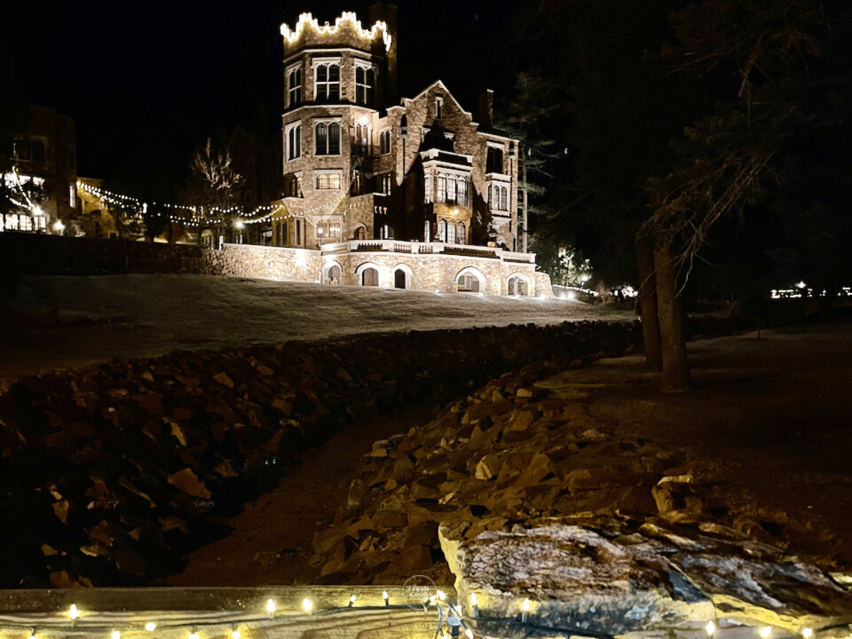 Glen Eyrie castle all decked out in lights at night. 