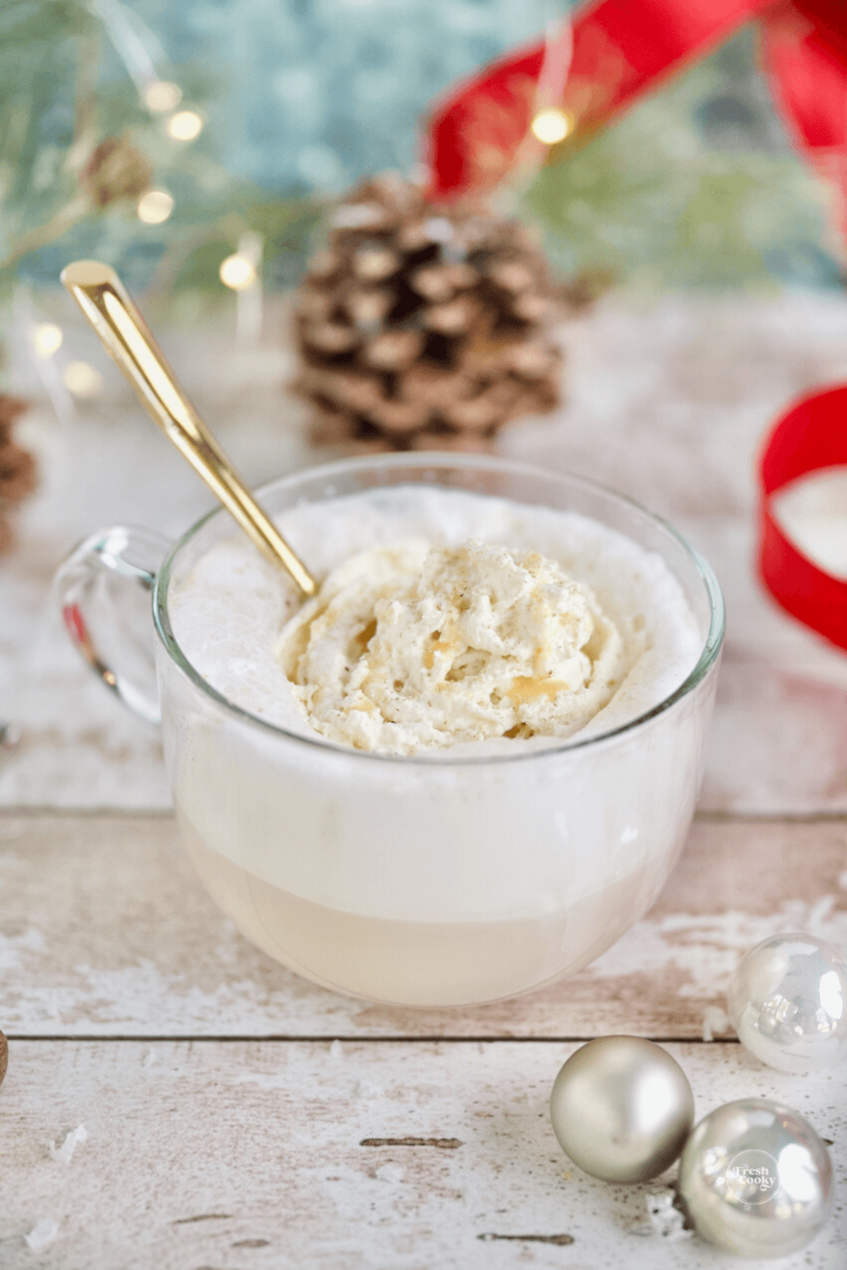 Hot Dutch Bros. Copycat Christmas Morning Chai latte in white mouth glass mug topped with whipped cream.