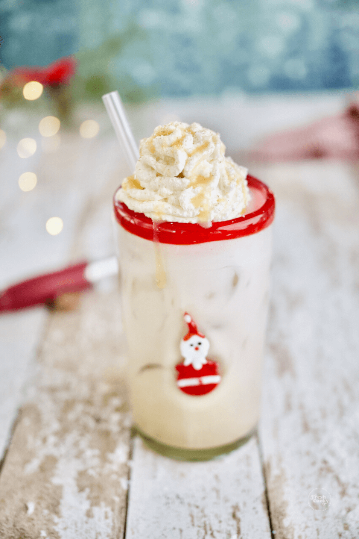 Iced Christmas morning chai latte recipe in cute Santa Glass with glass straw.