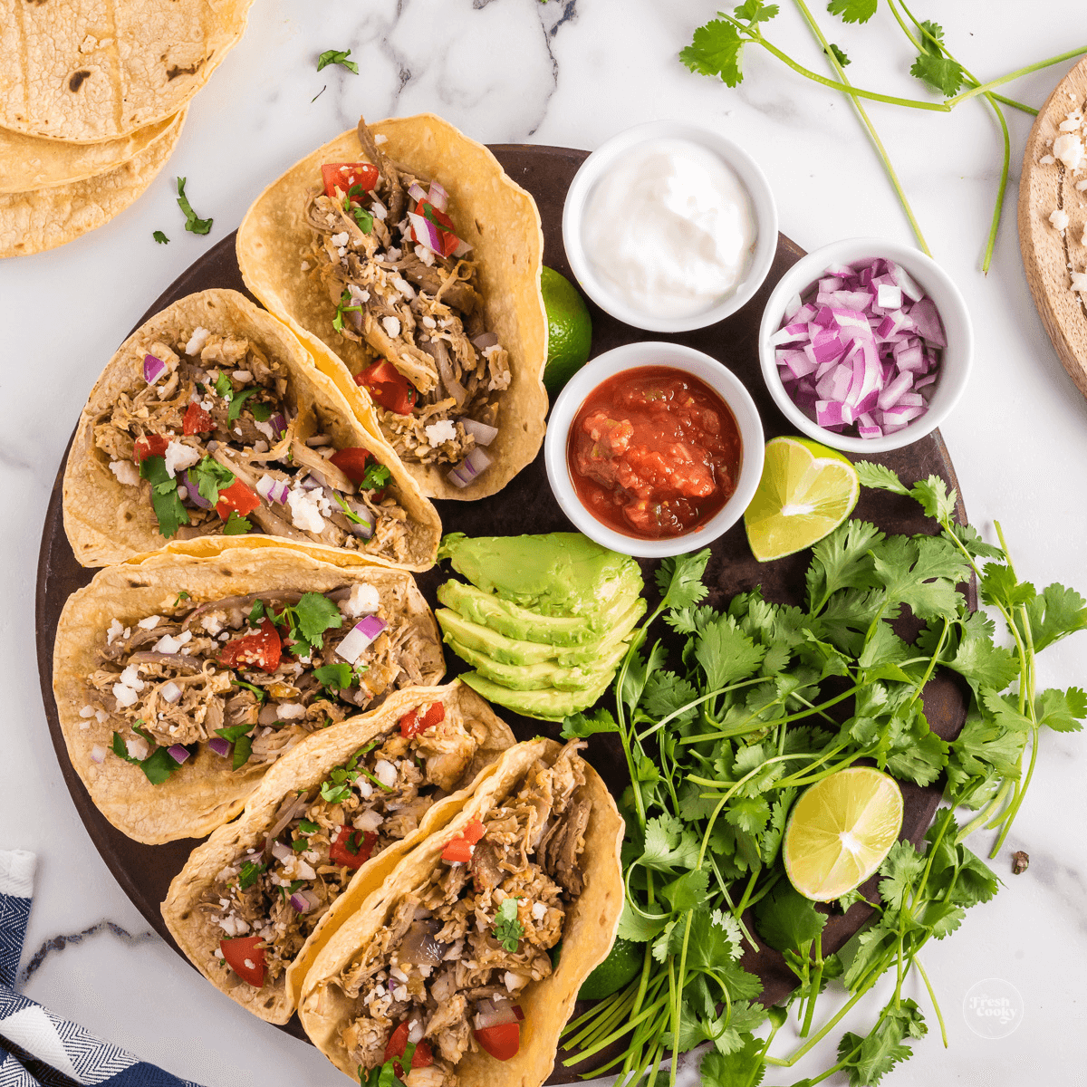 Leftover turkey tacos on platter with a variety of toppings.