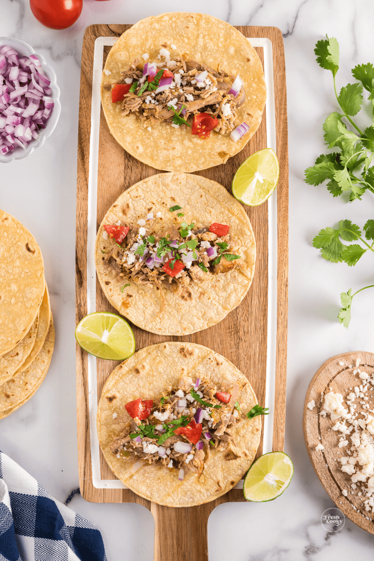 Adding toppings to leftover turkey tacos.