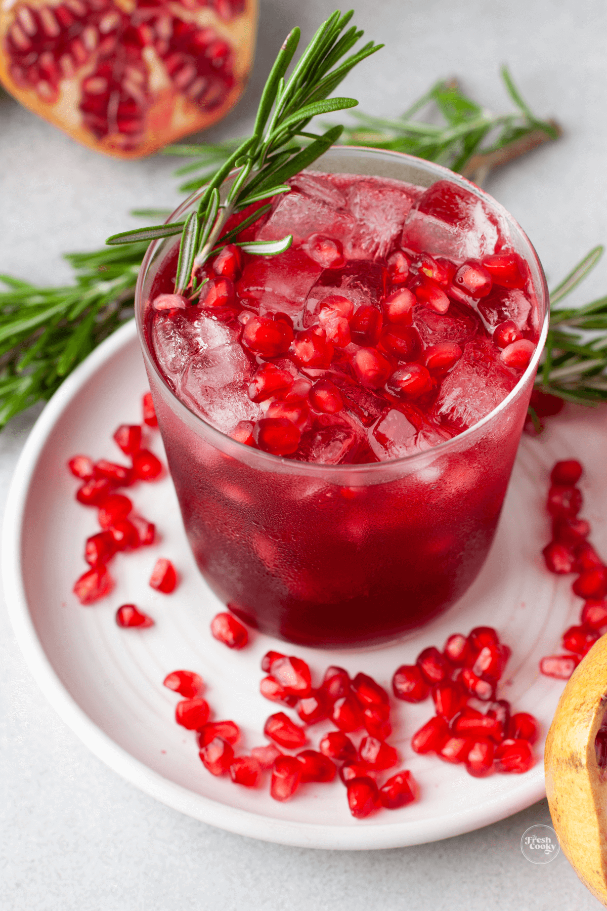 Mistletoe Margarita with pomegranate arils on a plate ready to drink.