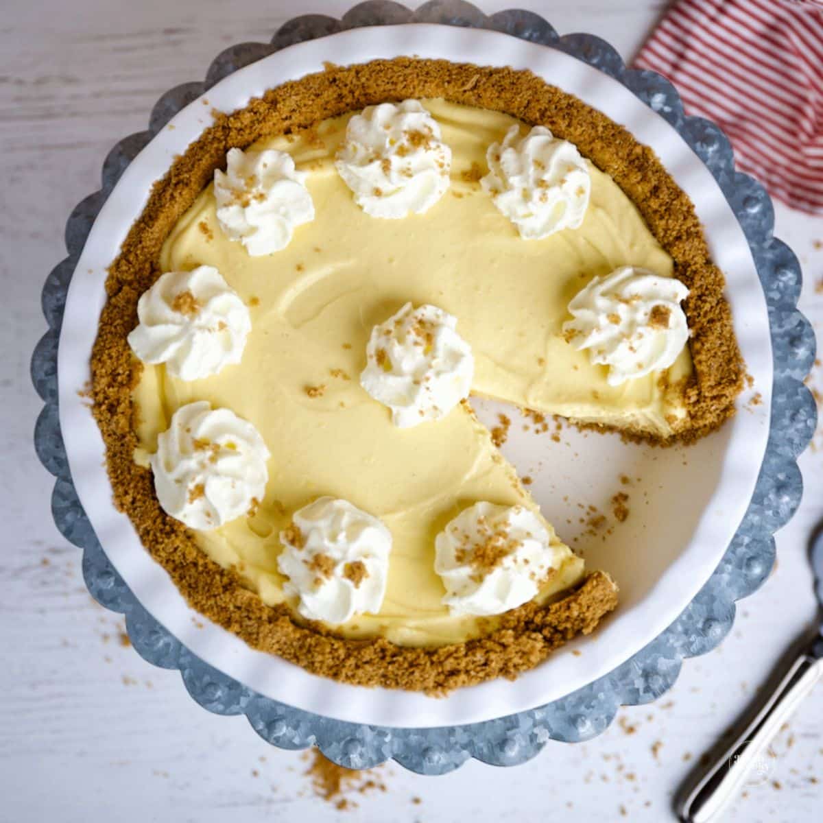 No bake eggnog pie with graham cracker crust, slice removed.