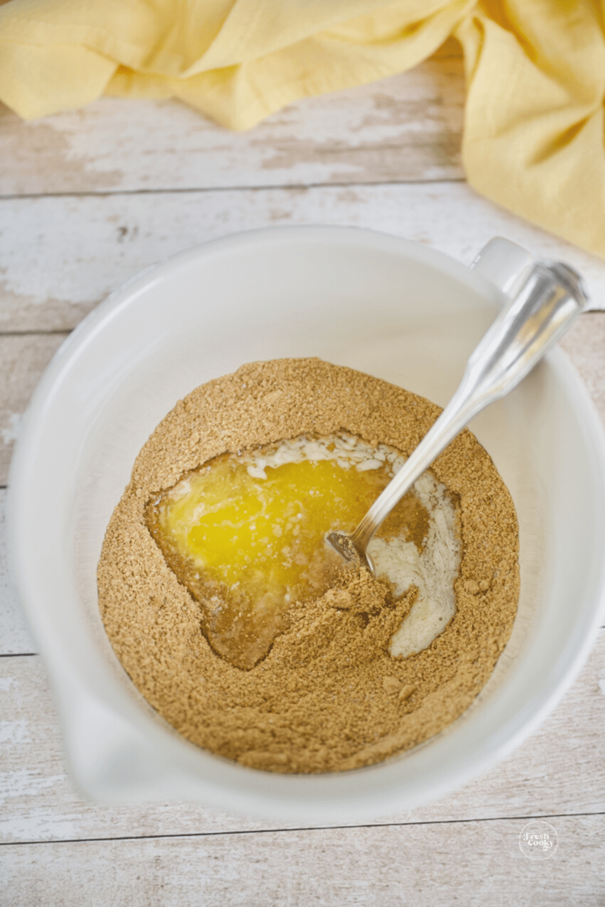 Mix together graham cracker crumbs sugar and butter with fork.