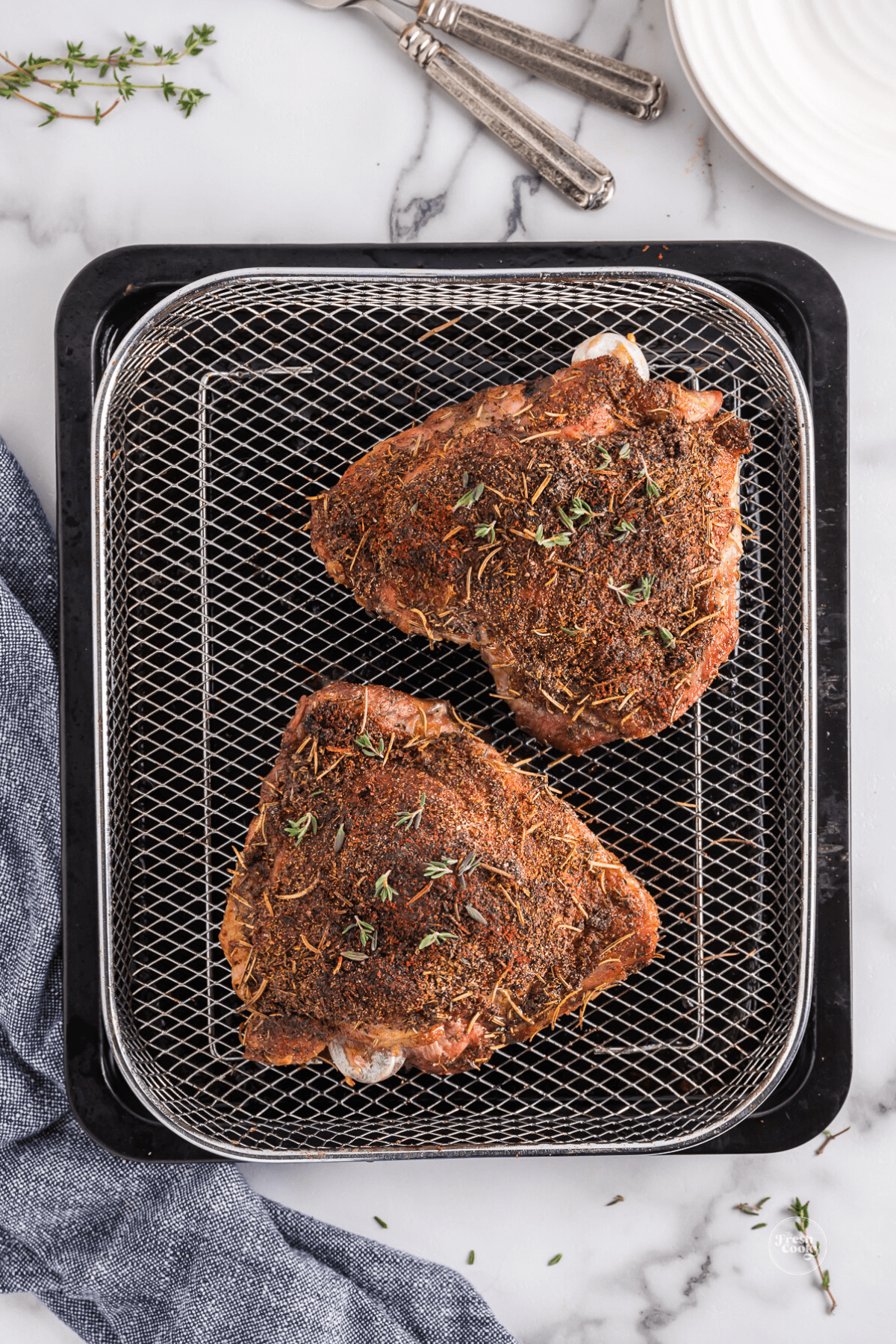 Air fryer turkey thighs in air fryer tray, finished.