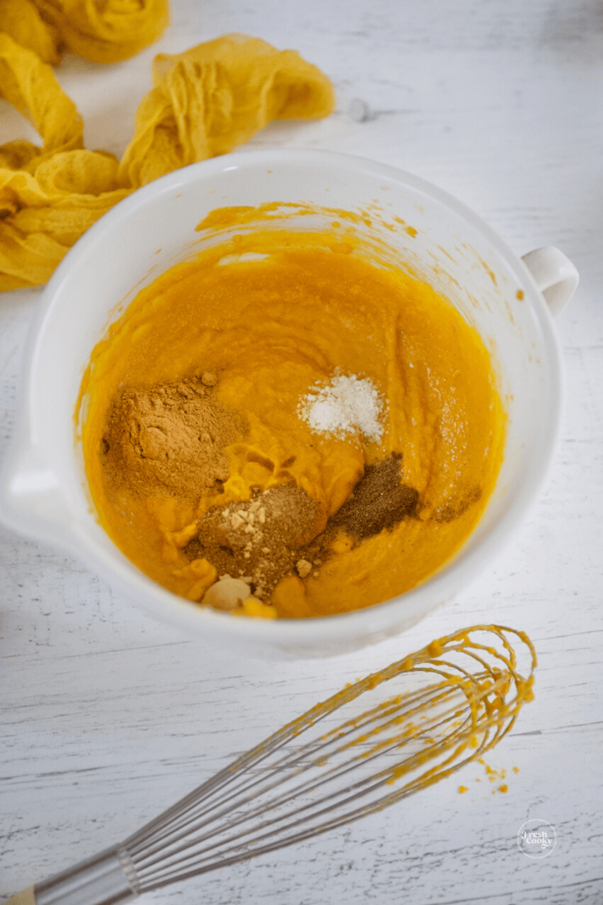 Spices and vanilla extract in pumpkin mixture. 