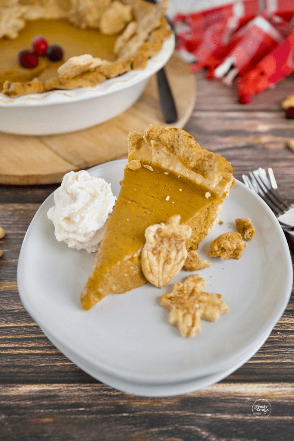 Slice of pumpkin custard pie costco copycat on plate with pastry cutouts.