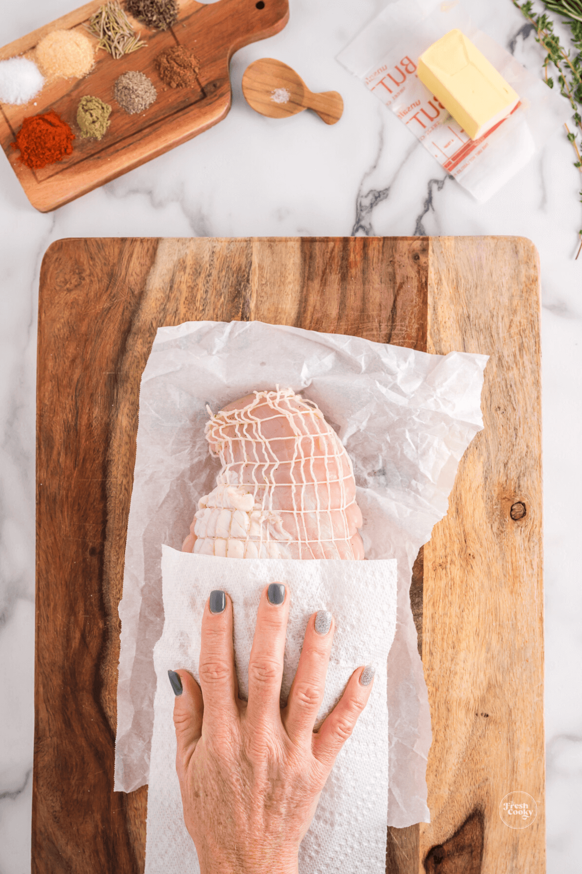 Hand drying the turkey breast.