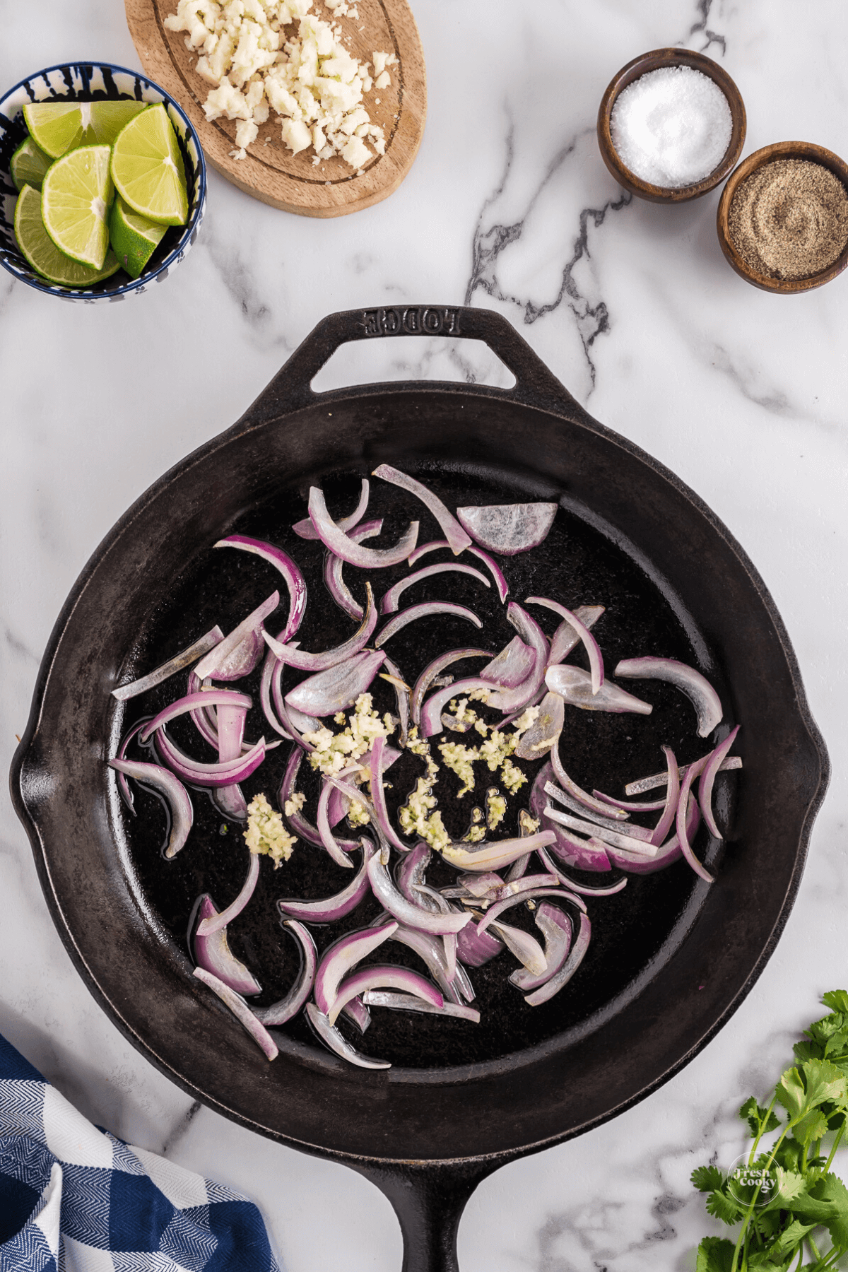Sauteing red onions and garlic in cast iron pan. 