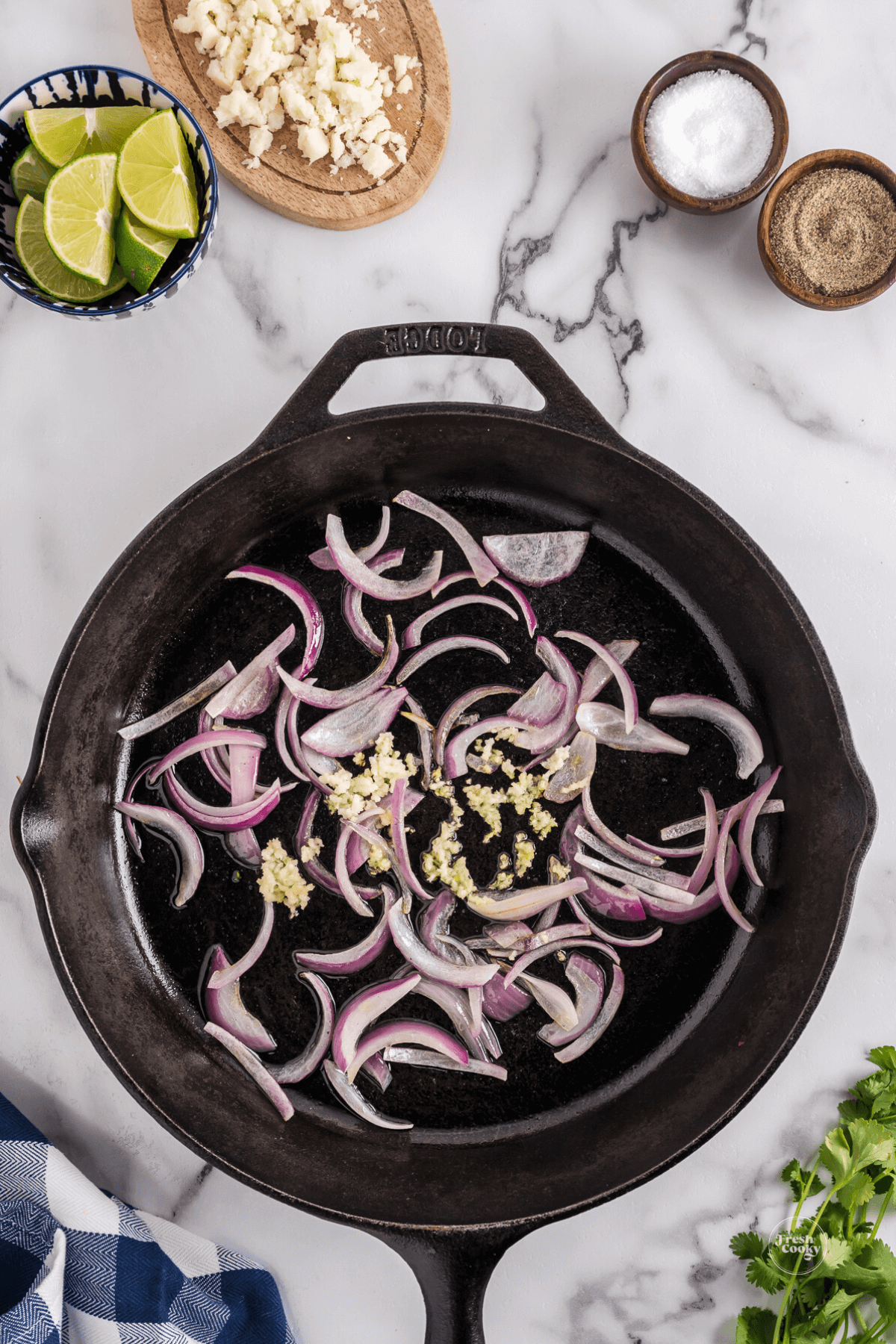 Sauteing red onions and garlic in cast iron pan.