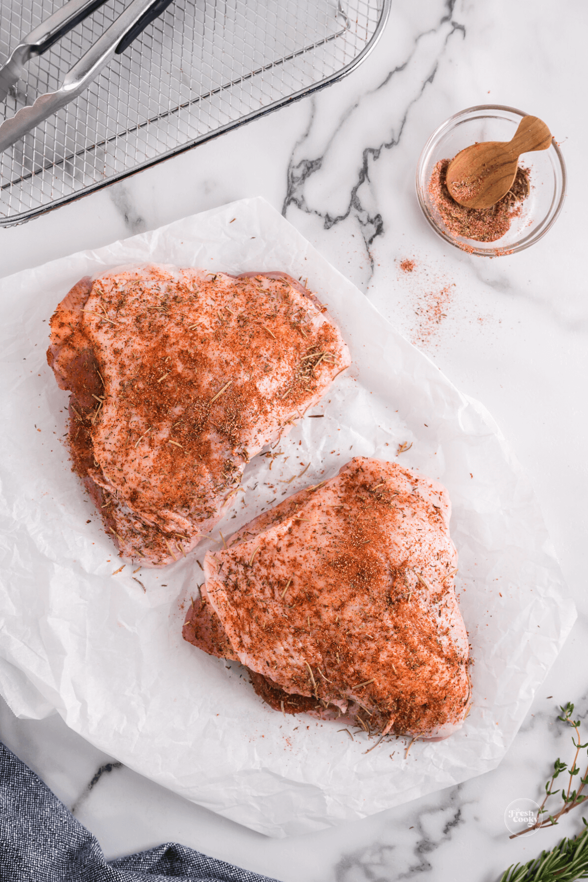 Rub seasoning on top of skin and under turkey thigh skin, all over.