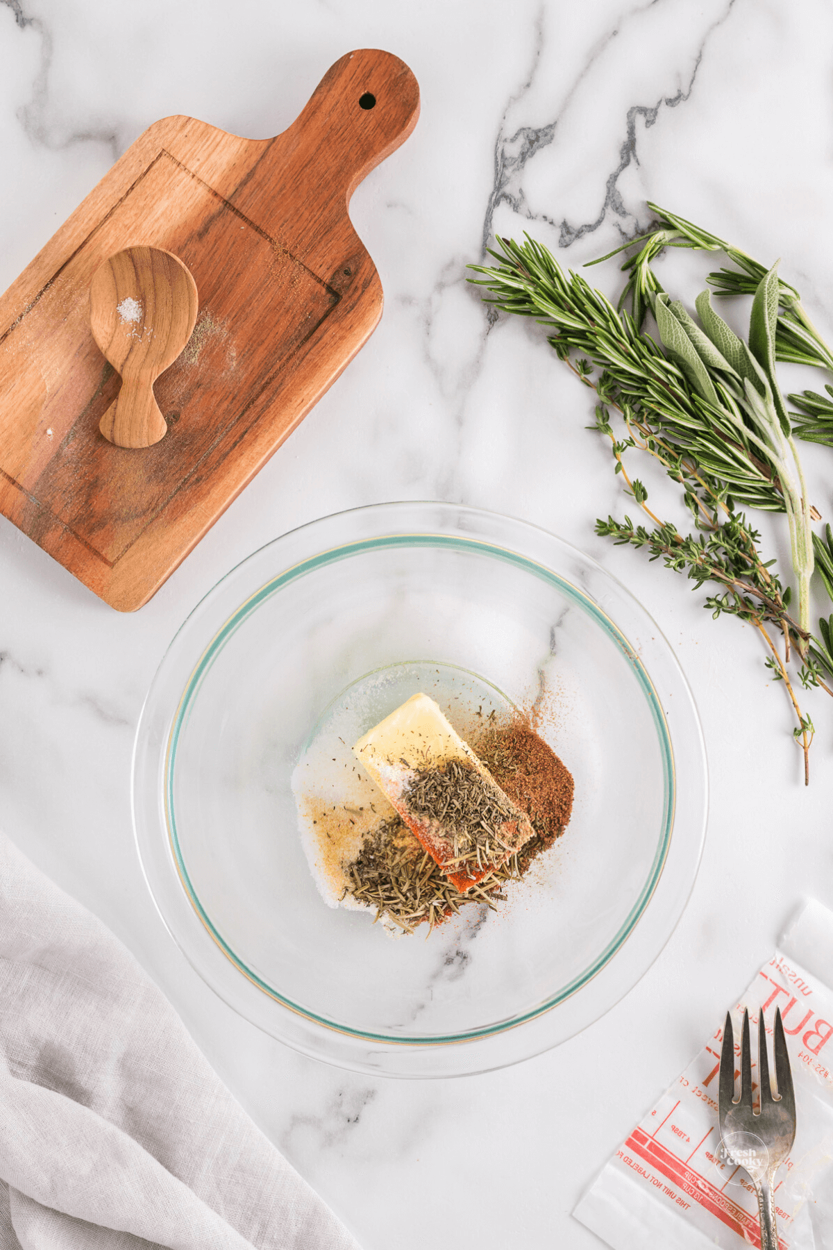 Spices and butter for herb rub in bowl. 