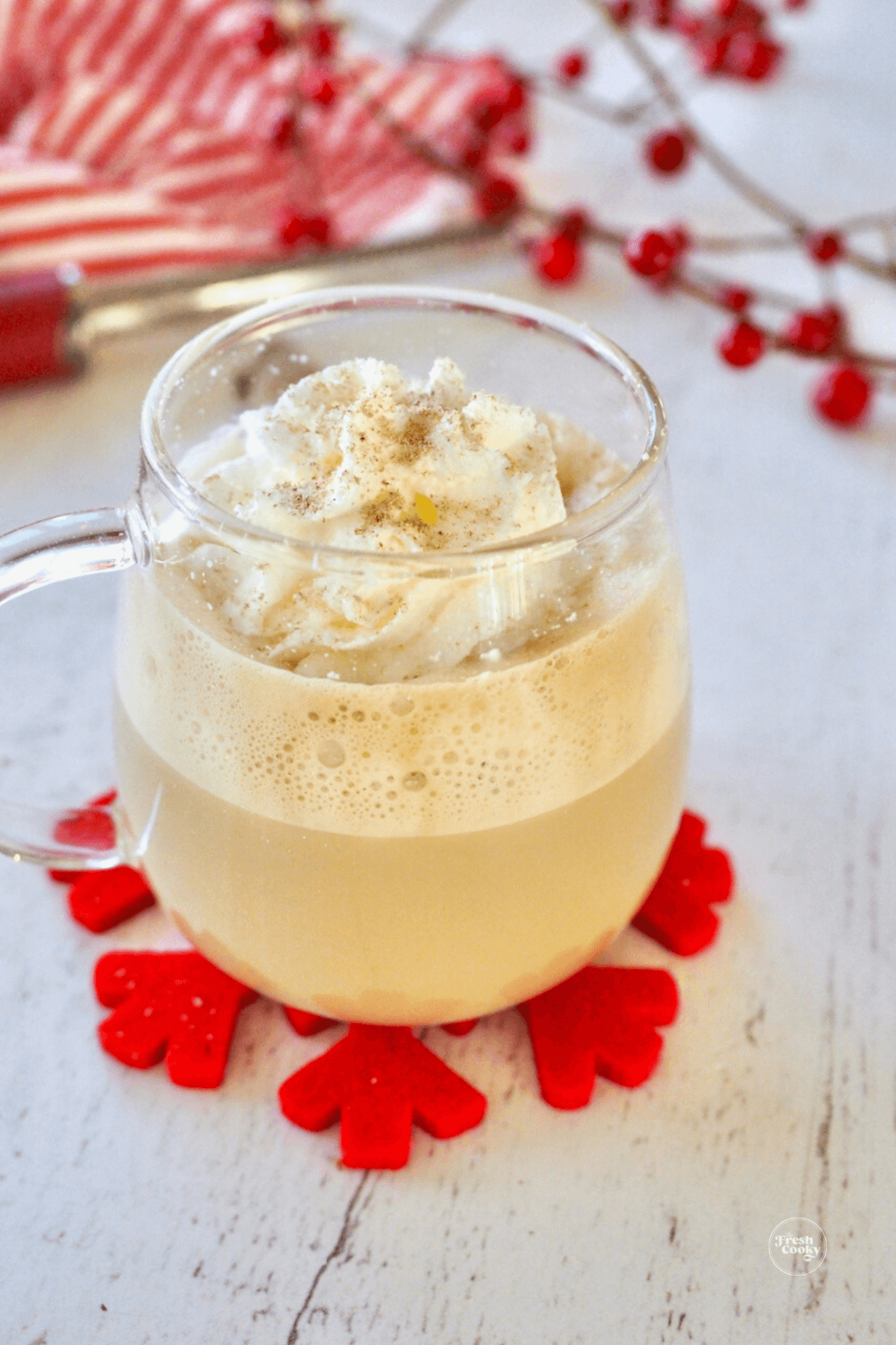 Starbucks eggnog latte in glass mug.