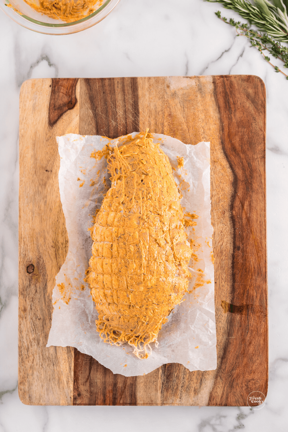 Herbed butter rubbed into turkey breast.