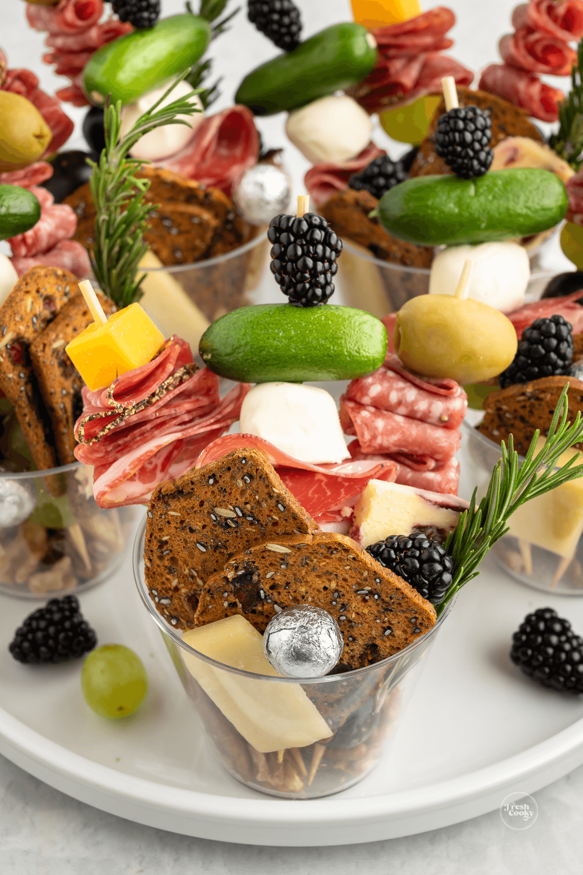 Charcuterie cups on tray ready for serving.