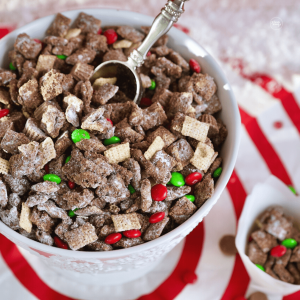 Christmas Reindeer Chex mix in bowl with a pretty scoop.