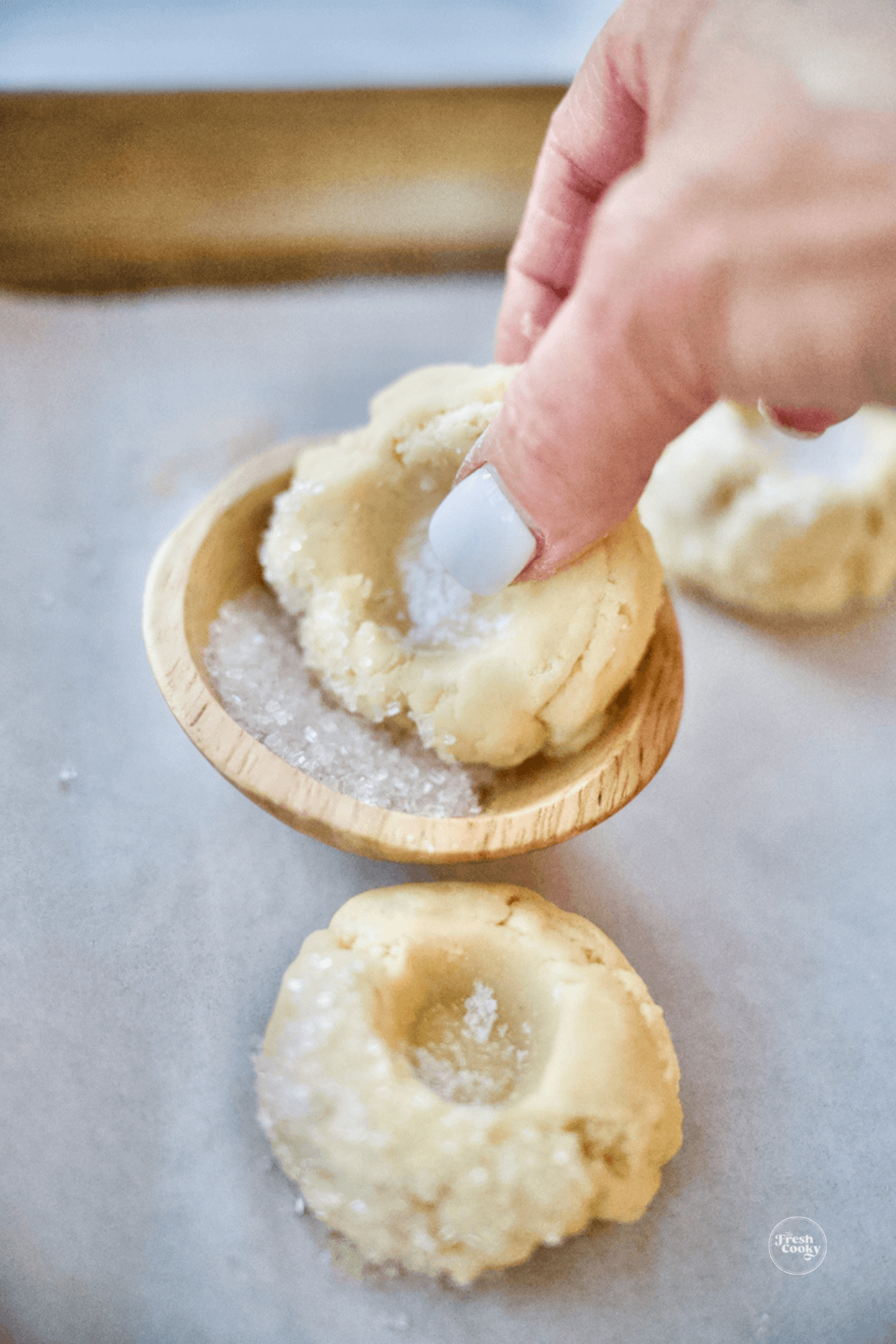 Optional rolling of edge of cookie dough into sparkling sugar. 