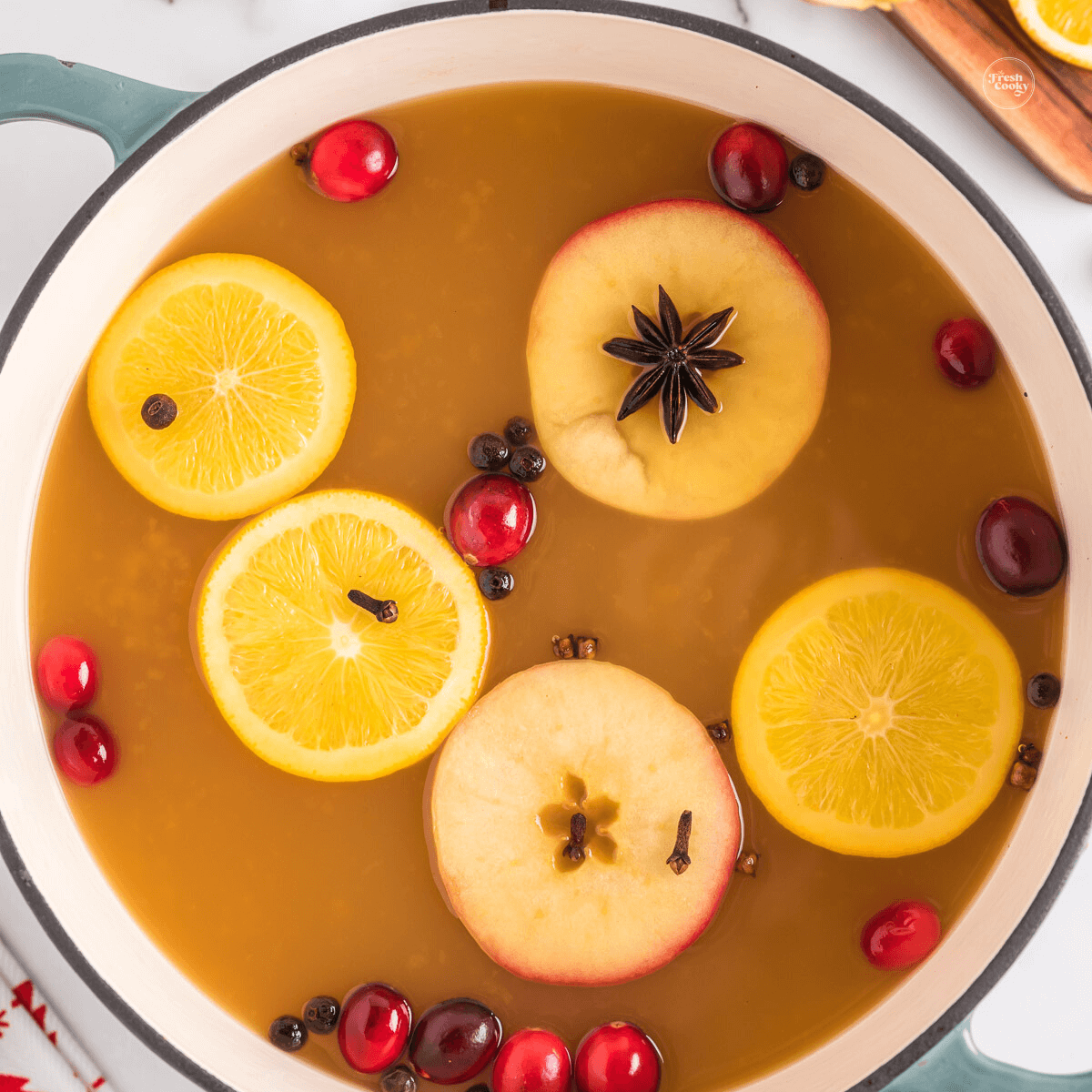 Wassail after simmering in pot with floating apples, oranges and spices. and ready to serve.