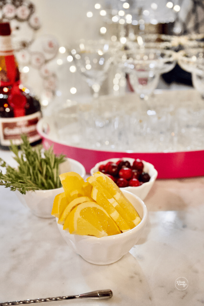 Sparkly festive drink station with garnishes.