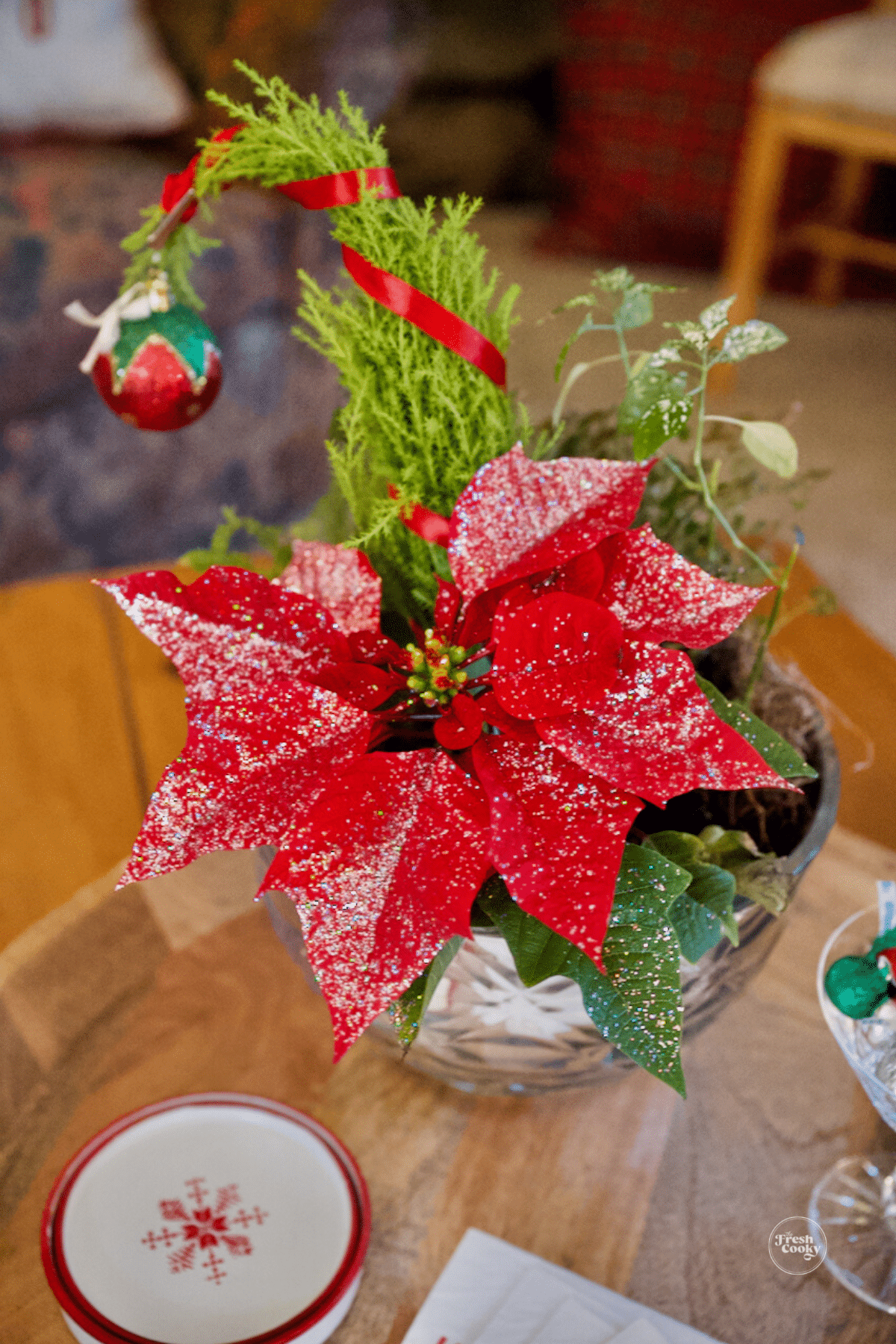 Grinch tree with poinsettia in inside pot. 