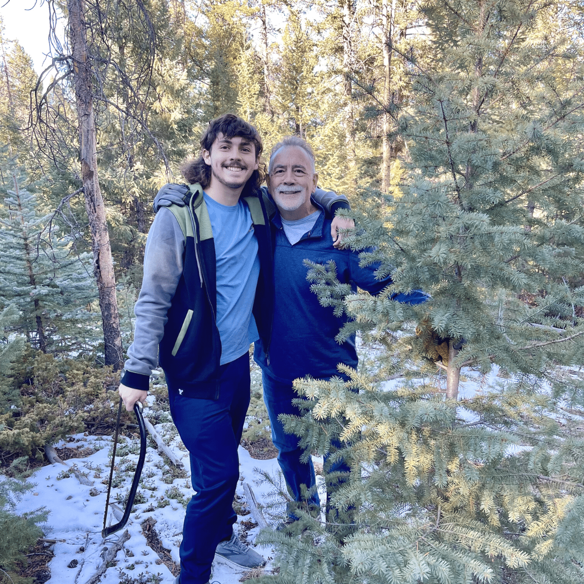 Hubs and son with Christmas tree at Singing Springs Ranch.