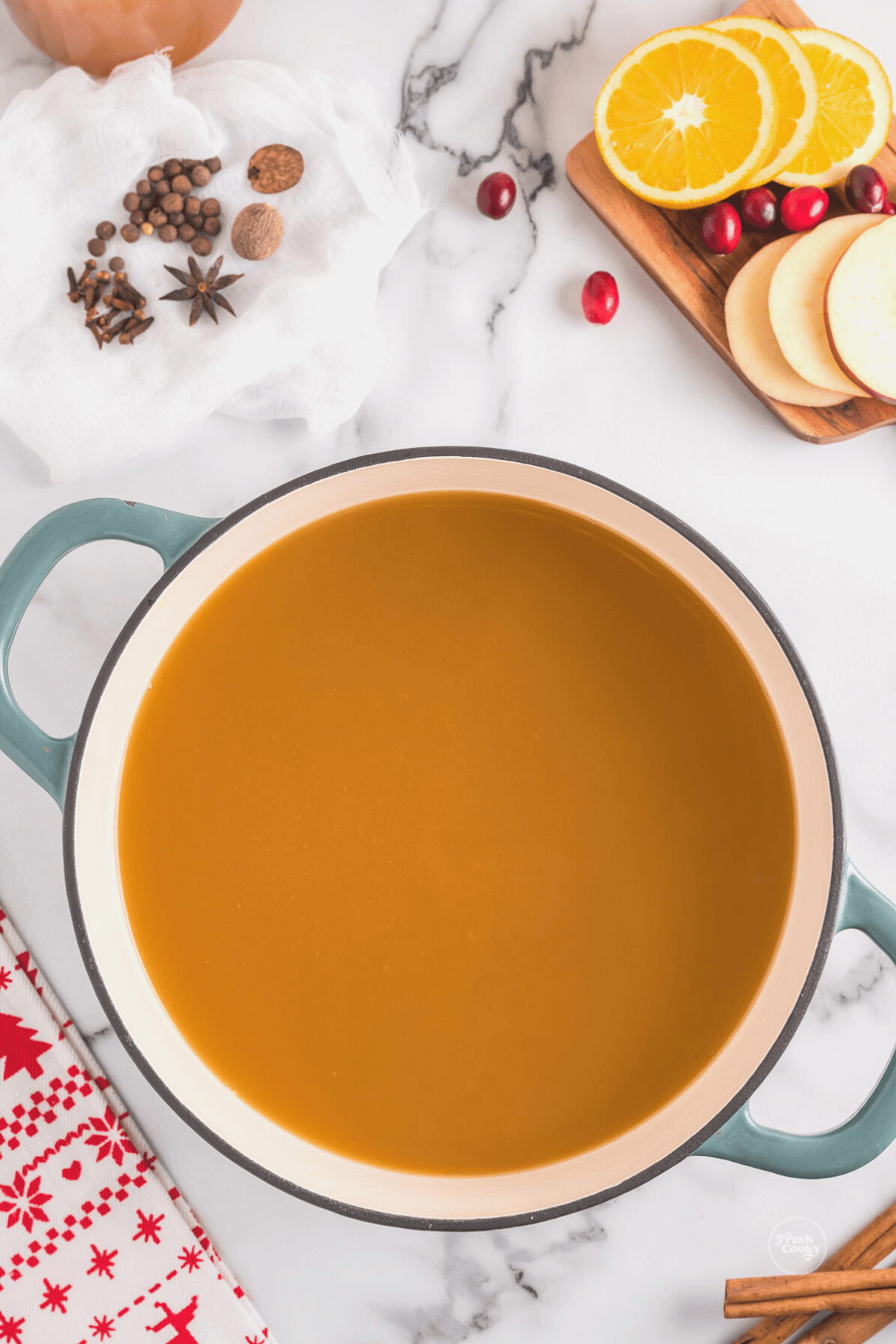 Juices and brown sugar poured into large heavy pot for wassail.